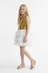 Vestido de tul y lentejuelas Riva blanco y dorado para niña: cuerpo de lentejuelas y falda de capas de tul, vista frontal de cuerpo entero