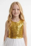 Vestido Riva blanco y dorado sin mangas: cuerpo de lentejuelas y tul blanco, vista frontal hasta la cintura