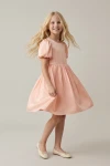 Vestido Sia rosa girando en el estudio, falda con vuelo en movimiento