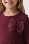Vestido Iga burdeos, primer plano del lacito doble de tul sobre el punto