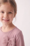 Vestido Iga rosa palo, primer plano del cuello redondo y el lacito de tul
